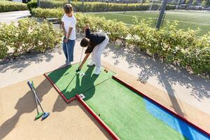 Cute little girl playing golf photo