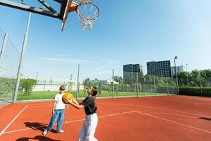 Children and sports. Teenage girl playing basketball on the playground. photo