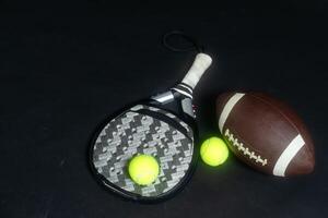 Set of sport equipment on floor, padel tennis, ball rugby photo