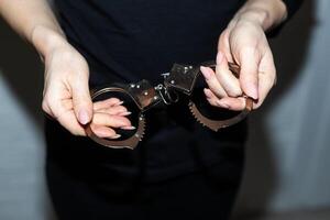 steel handcuffs of police special equipment, fetters on a black background photo