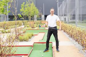 player looks at his hit on a mini golf course photo