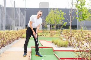 Minigolf player detail on green grass photo