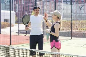 Padel lesson with a coach, personalized instruction in a supportive environment. photo