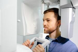 Panoramic image of teeth. A patient in a modern dental clinic takes a panoramic picture of the teeth. Prevention of dental diseases. Accurate diagnosis. photo