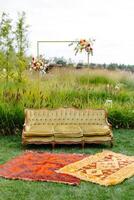 Outdoor couch and rug on grass photo