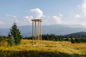 Tall wooden structure in field photo