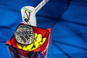 Ukraine Kyiv, April 02 2024. paddle tennis racket and balls on the blue paddle court photo