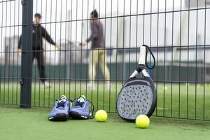 Padel tennis racket sport court and balls. Download a high quality photo with paddle for the design of a sports app or soical media advertisement