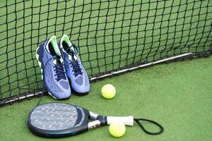 Padel tennis racket sport court and balls. Download a high quality photo with paddle for the design of a sports app or soical media advertisement