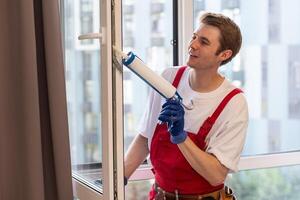 A repairman fixing windows in new apartment photo