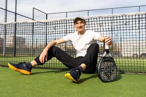 man playing paddle tennis court photo