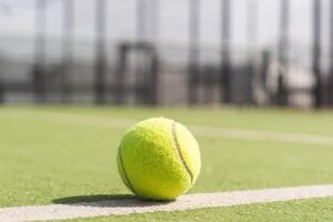 Tennis ball on a tennis court next to the side line photo