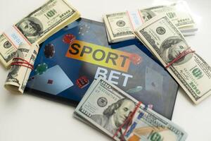 Smartphone with gambling mobile application and soccer ball with money close-up. Sport and betting concept photo