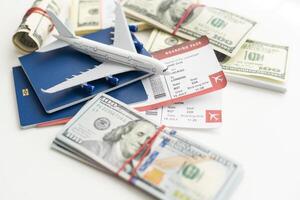 Airplane and money. Plane on the background of USA dollars. The cost of travel, air tickets and flights, financial expenses for vacation. photo