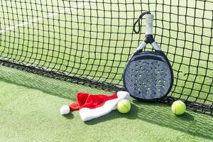 padel racket and santa hat photo