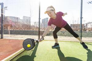 Portrait of attractive woman padel tennis player in outdoor court. photo