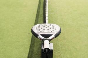 paddle tennis racket, ball. close- up on the racket photo