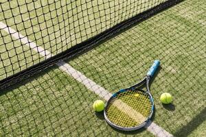 Tennis racket with a set of balls photo