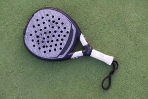 Paddle tennis objects on grass court photo