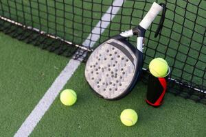 professional paddle tennis racket with natural lighting on court background. Horizontal sport theme poster, greeting cards, headers, website and app photo