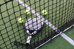 Paddle tennis objects on grass court photo