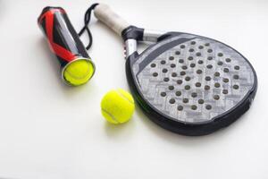 Set of paddle tennis rackets and balls the reflected on white table and white isolated background. Front view. photo