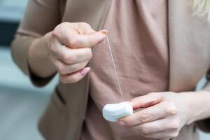 Dental floss in the hands close up photo