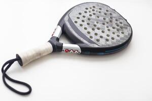 Set of paddle tennis rackets and balls the reflected on white table and white isolated background. Front view. photo