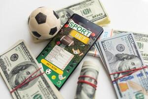 tablet pc with app for sport bets, on top of stacks of banknotes, white background, concept of online bets 3d render photo