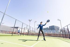 One women playing Paddle tennis photo