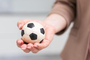 Woman hand with football on white background photo