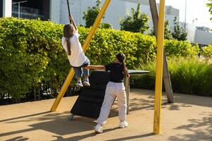 Girl playing on a swing in the park photo