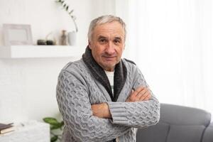 Portrait of a stylish modern elderly man on a white background in the studio. Senior boss thinking in a pensive pose photo