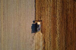 Combine harvester working in agricultural field. Harvest season photo