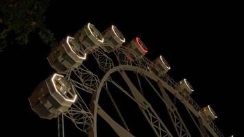 Illuminated ferris wheel at night video