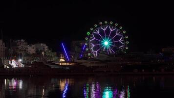 Ferris wheel illuminated in night sky video