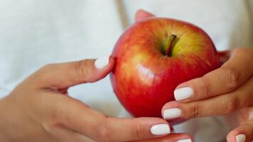 Woman holding apple in hands video