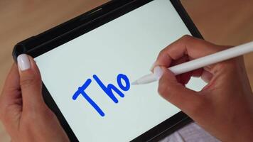 Person holding tablet with pen and write Thanks video