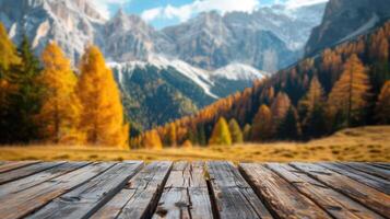 Wooden table top on blurred background of autumn color landscape in dolomites - for display your products photo