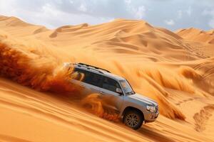 A powerful SUV performs a dynamic slide on the sandy desert dunes with dust clouds billowing around it photo