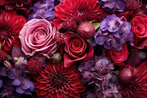Red and purple flowers such as roses and dahlias photo