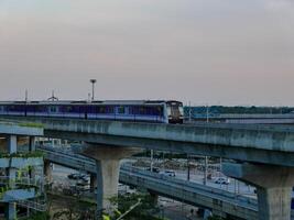 Nonthaburi-Thailand April 16, 2024 The Electric Sky Train MRT Purple line passes through Central Westgate Department store The biggest shopping plaza in the evening at Bang Yai, Nonthaburi Thailand. photo