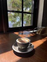 Cozy Coffee Cup by Sunny Window with Tropical View photo