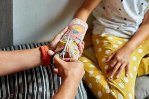 Father removing a plaster cast teen girl with a broken arm photo