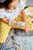 Teen girl with a broken arm at home an orthopedic cast photo