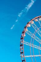 View of the Ferris wheel attraction against a background of blue sky. Ferris wheel in the Georgian city of Batumi. photo