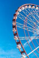 View of the Ferris wheel attraction against a background of blue sky. Ferris wheel in the Georgian city of Batumi. photo