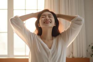 Beautiful young asian woman wake up in the morning photo