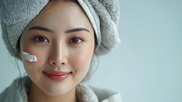 beautiful young aisan woman with towel on her head photo