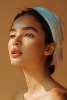 beautiful young aisan woman with towel on her head photo